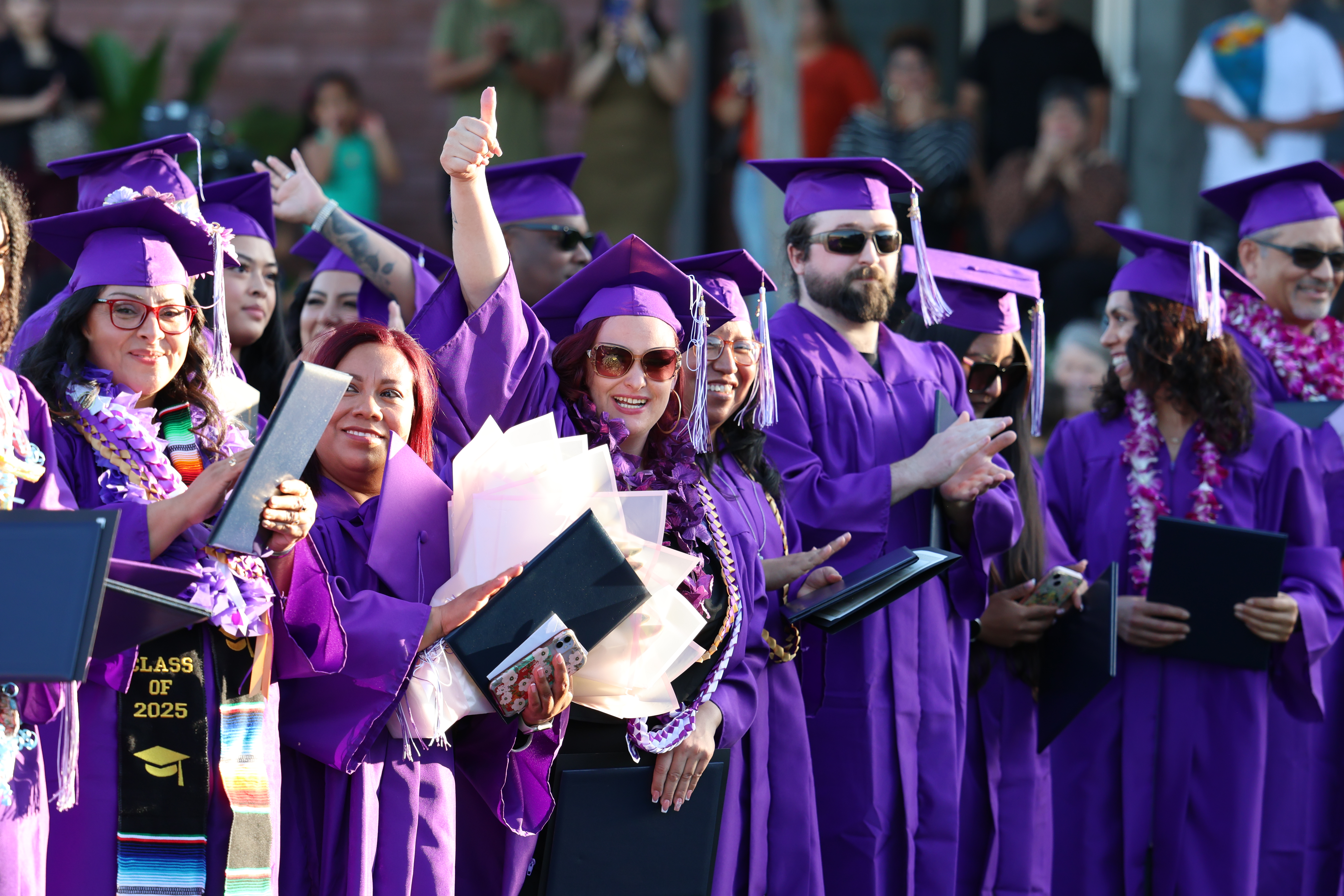 graduate hugging a person